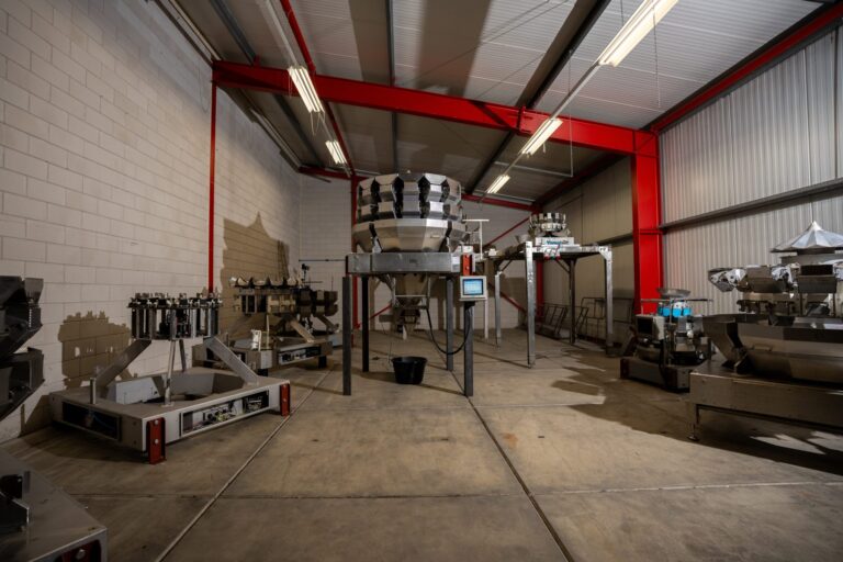 Yamato multihead weger met besturingsscherm in de werkplaats van STC Food Solutions, met meerdere wegers op de achtergrond